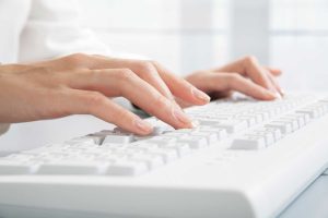 hands typing transcription
